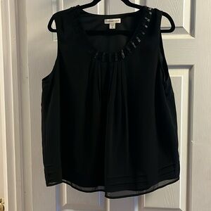 Women’s black sleeveless dress top.